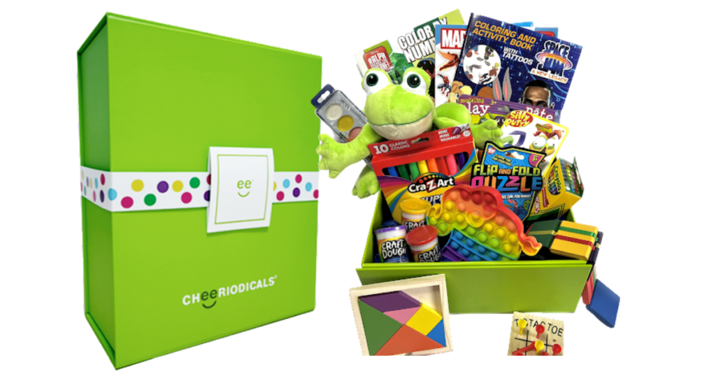 Cheeriodicals green box and toys that go inside such as coloring books and a green stuffed frog